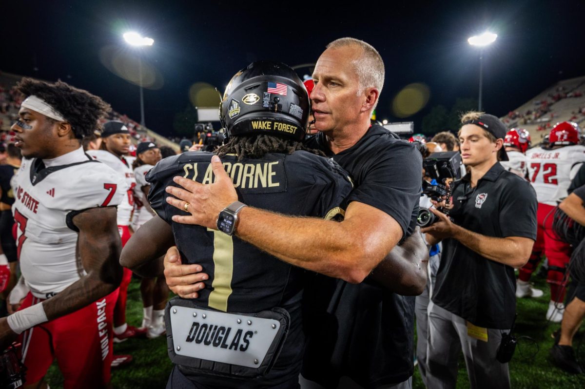 Head coach Dave Doeren embraces Wake Forest runningback Demond Claiborne after the game against Wake Forest in Allegacy Stadium on Thursday, Sept. 11, 2025. Claiborne has been a four-year starter in the ACC. The Wolfpack beat the Demon Deacons 34-24.