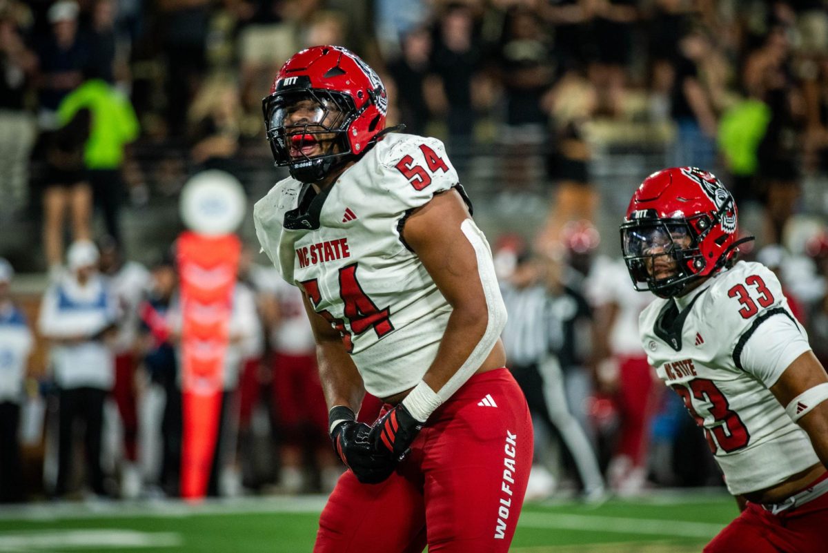 Graduate defensive end Sabastian Harsh celebrates after delivering a big hit during the game against Wake Forest in Allegacy Stadium on Thursday, Sept. 11, 2025. Harsh would later be ejected from the game for a targeting penalty. The Wolfpack beat the Demon Deacons 34-24.