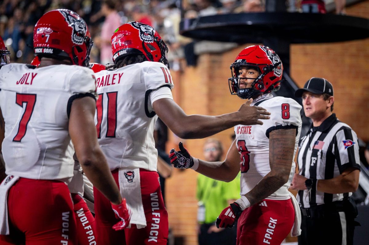 Sophomore wide reciever Keenan Jackson and sophomore quarterback CJ Bailey celebrate after a touchdown during the game against Wake Forest in Allegacy Stadium on Thursday, Sept. 11, 2025. The Wolfpack beat the Demon Deacons 34-24.