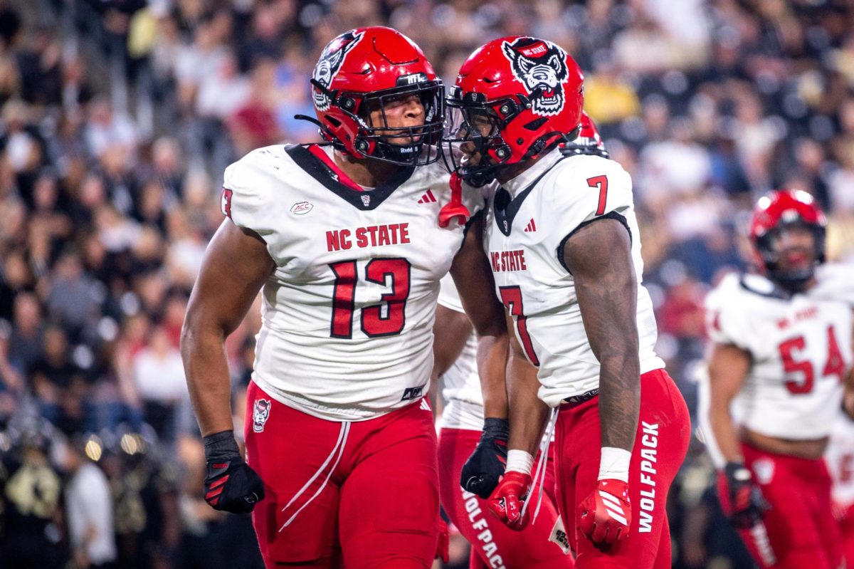 Graduate defensive end Travali Price and redshirt sophomore cornerback Brian Nelson II celebrate a big stop during the game against Wake Forest in Allegacy Stadium on Thursday, Sept. 11, 2025. The Wolfpack beat the Demon Deacons 34-24.