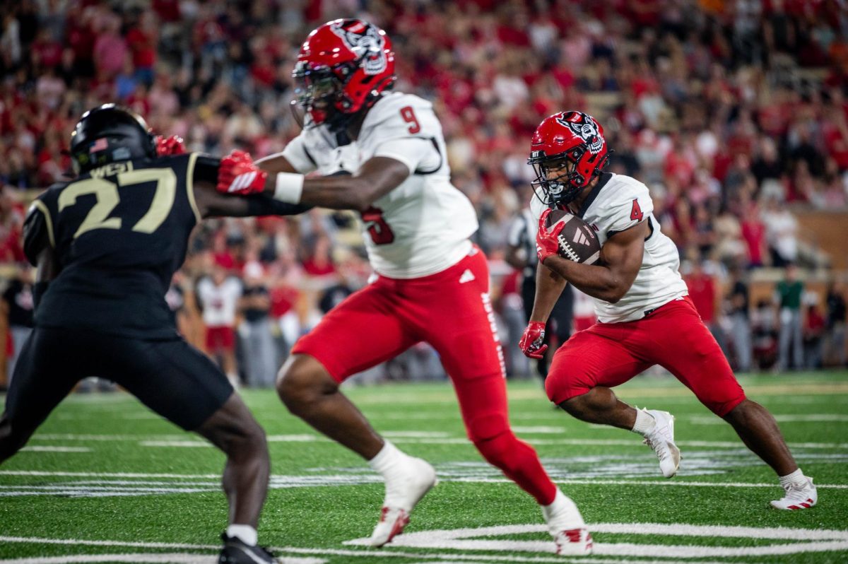 Redshirt freshman runningback Duke Scott looks for a crease during the game against Wake Forest in Allegacy Stadium on Thursday, Sept. 11, 2025. The Wolfpack beat the Demon Deacons 34-24.