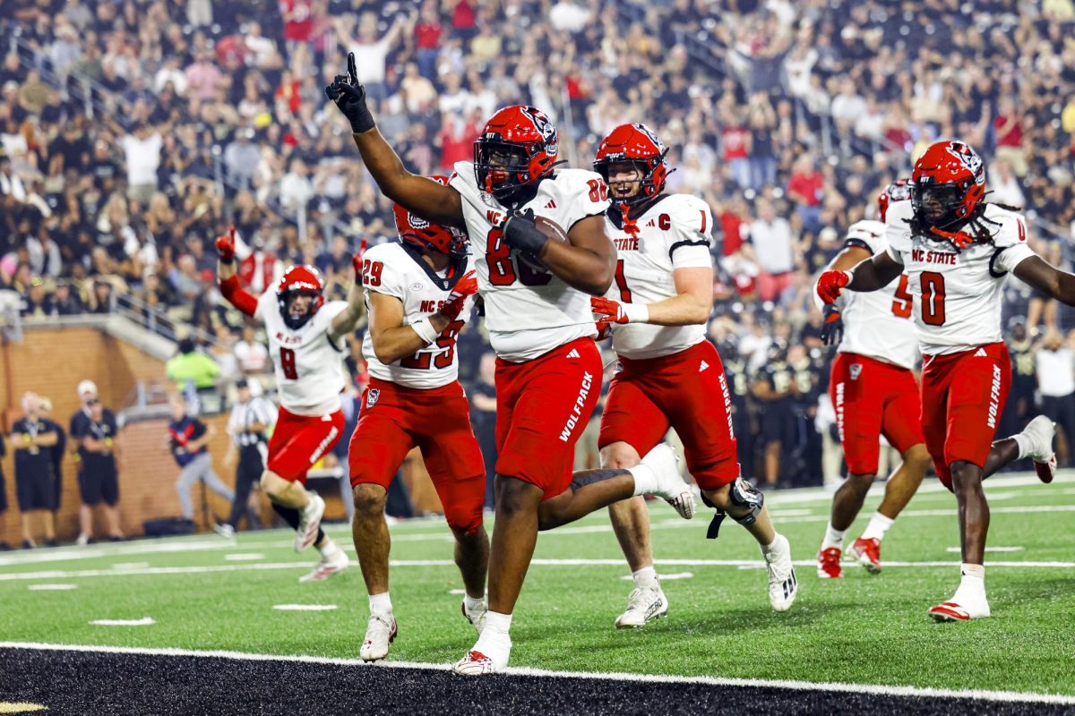 Redshirt sophomore defensive end Isaiah Shirley celebrates while returning an interception for a touchdown during the game against Wake Forest in Allegacy Stadium on Thursday, Sept. 11, 2025. The Wolfpack beat the Demon Deacons 34-24.