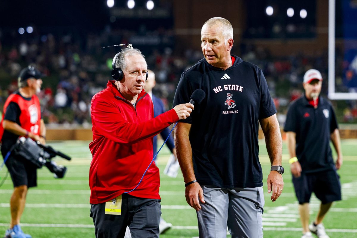 Head Coach Dave Doeren talks to a reporter during halftime during the game against Wake Forest in Allegacy Stadium on Thursday, Sept. 11, 2025. The Wolfpack beat the Demon Deacons 34-24.