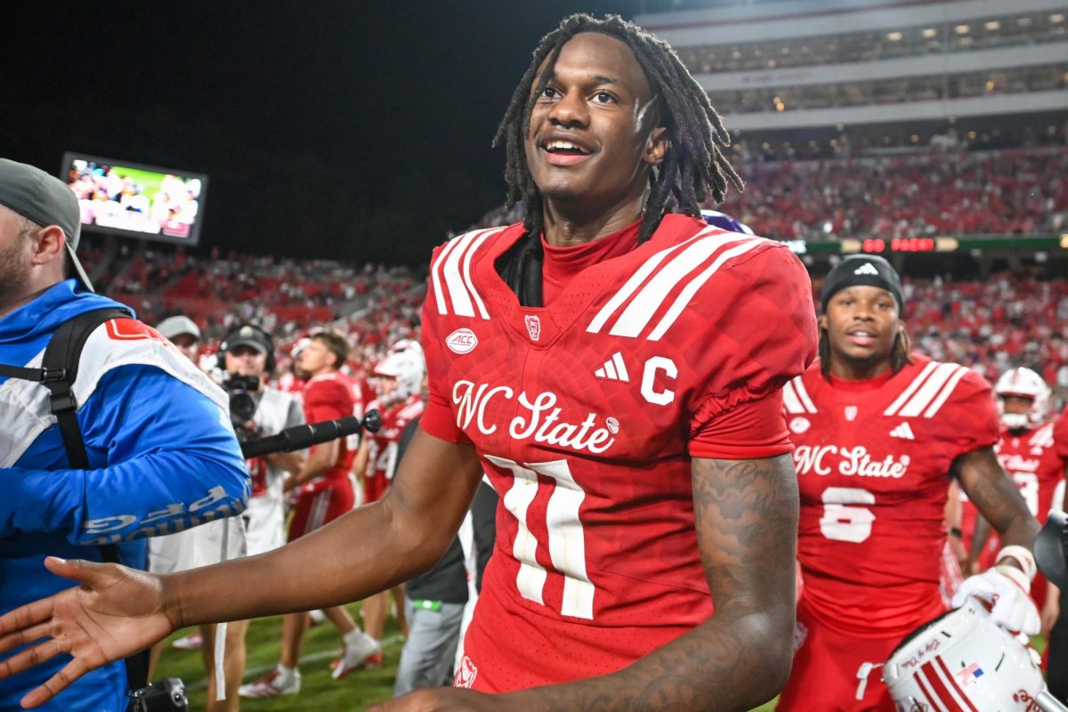 Sophomore quarterback CJ Bailey walks onto the field following the football game against East Carolina at Carter-Finley Stadium on Thursday, Aug. 28, 2025.  Bailey passed for a total of 318 yards and recorded a rushing touchdown. The Wolfpack defeated the Pirates 24-17.
