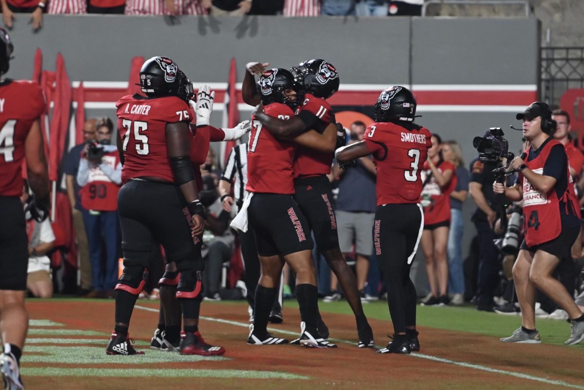 Sophomore quarterback CJ Bailey and redshirt senior tight end Dante Daniels embrace during the game against Virginia Tech at Carter-Finley Stadium on Saturday, Sept. 27, 2025. Bailey recorded 240 passing yards. NC State lost the game 23-21.
