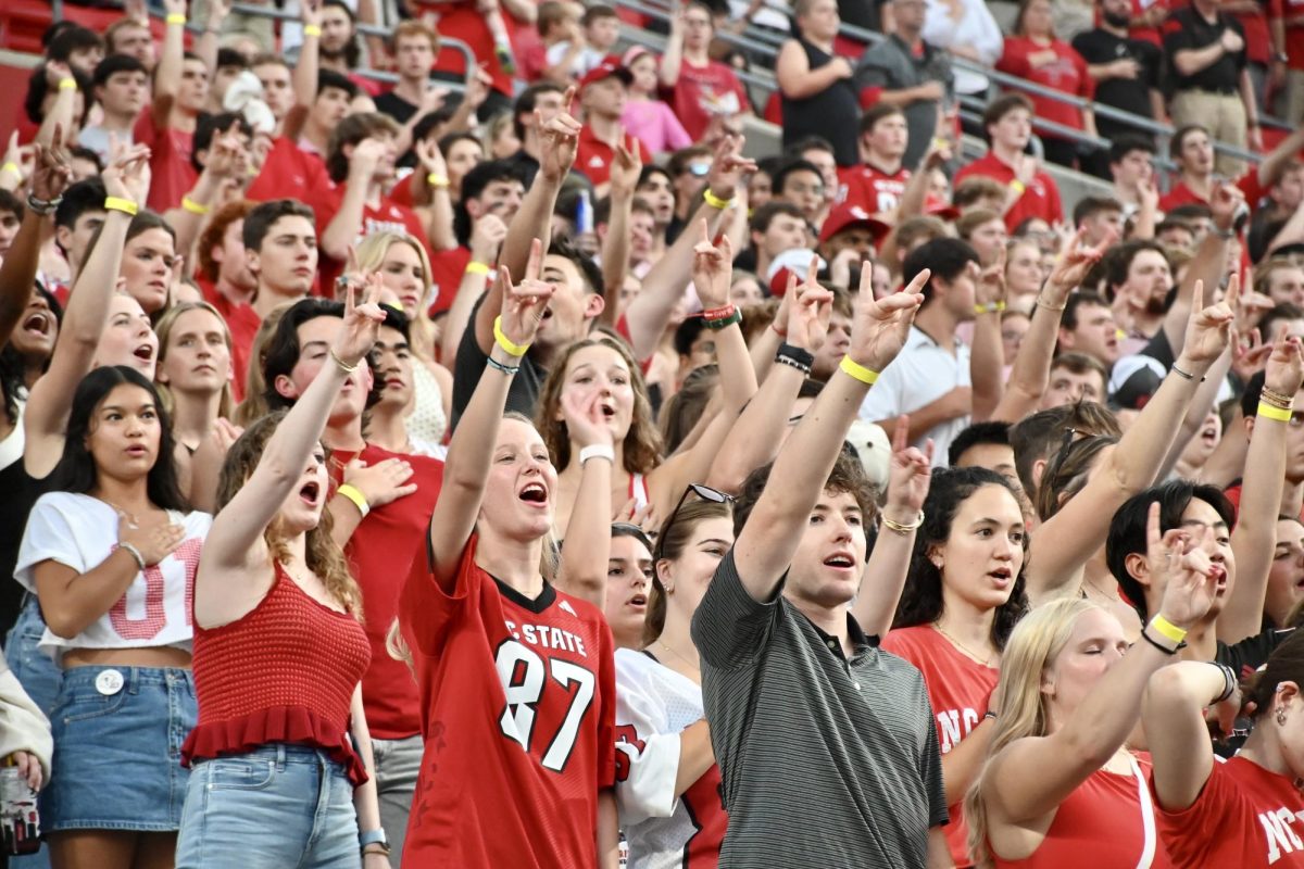 NC State fans hold up “wolfies” during the game against Virginia Tech at Carter-Finley Stadium on Saturday, Sept. 27, 2025. NC State lost the game 23-21. NC State lost 23-21.