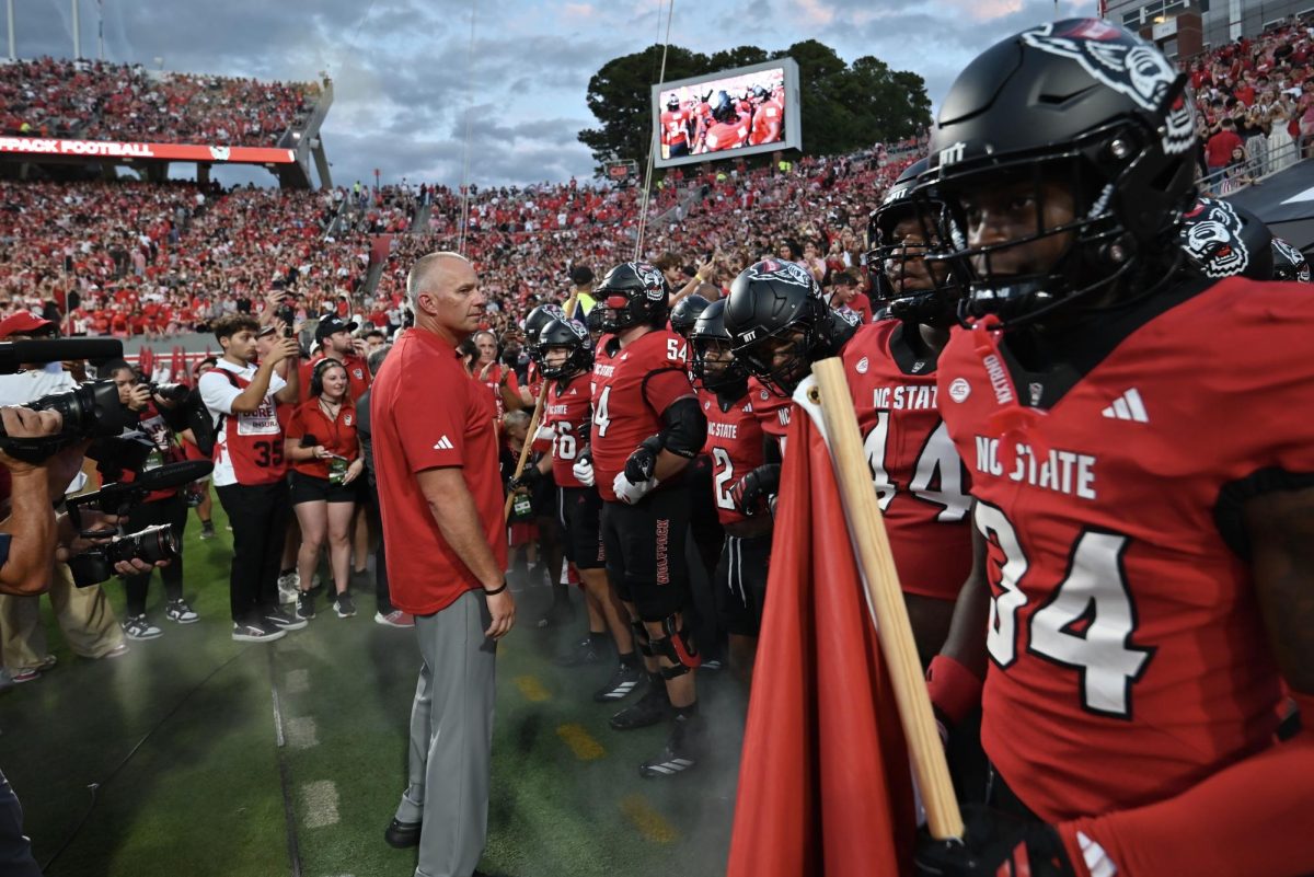 Head Coach Dave Doeren leads the team onto the field of the game against Virginia Tech at Carter-Finley Stadium on Saturday, Sept. 27, 2025. NC State lost the game 23-21.