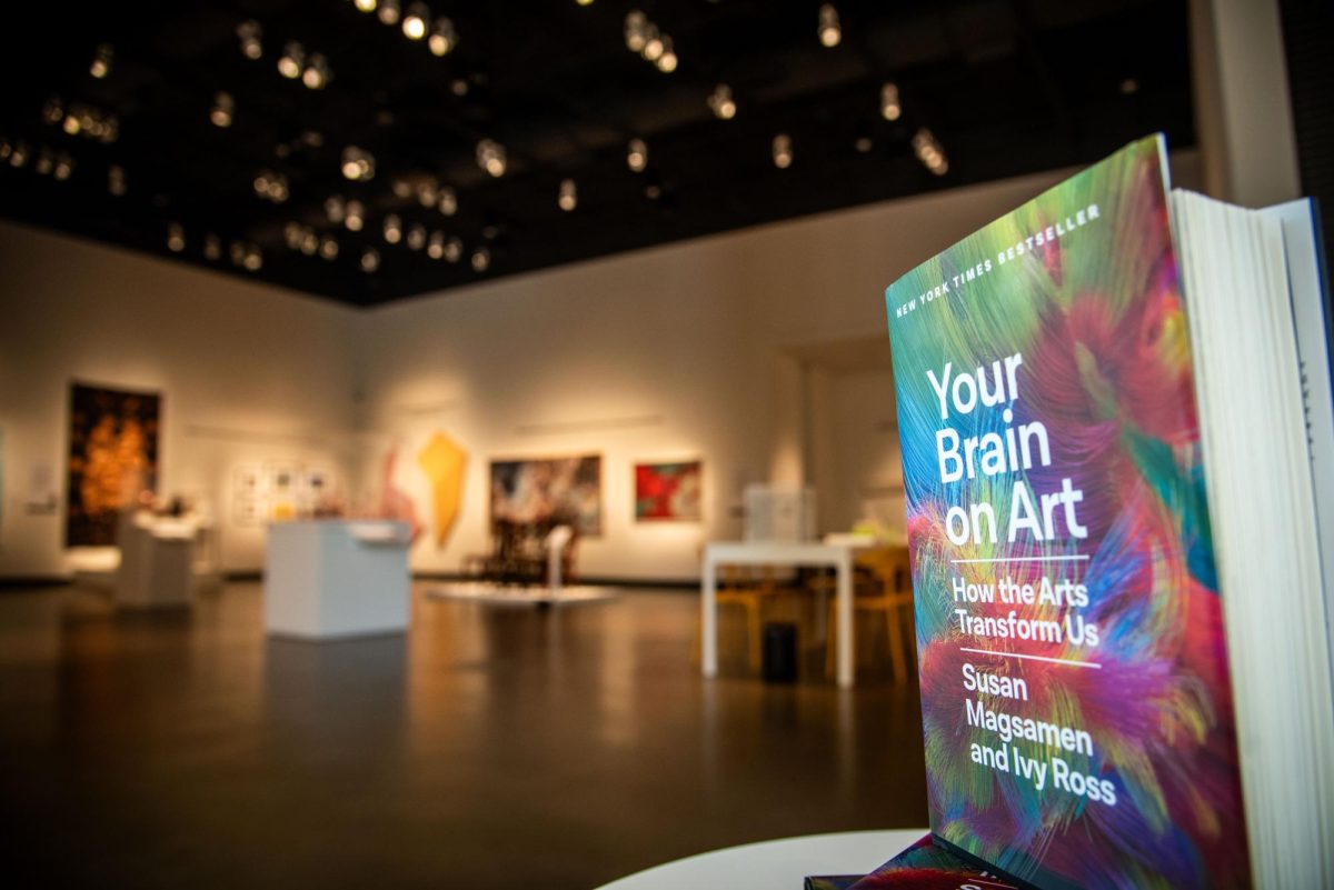 Susan Magsamen and Ivy Ross’s best-selling book, “Your Brain on Art: How the Arts Transform Us,” sits in front of the exhibition in the Gregg Museum of Art and Design on Friday, Sept. 12, 2025. The exhibit positions artwork around quotes from the novel.