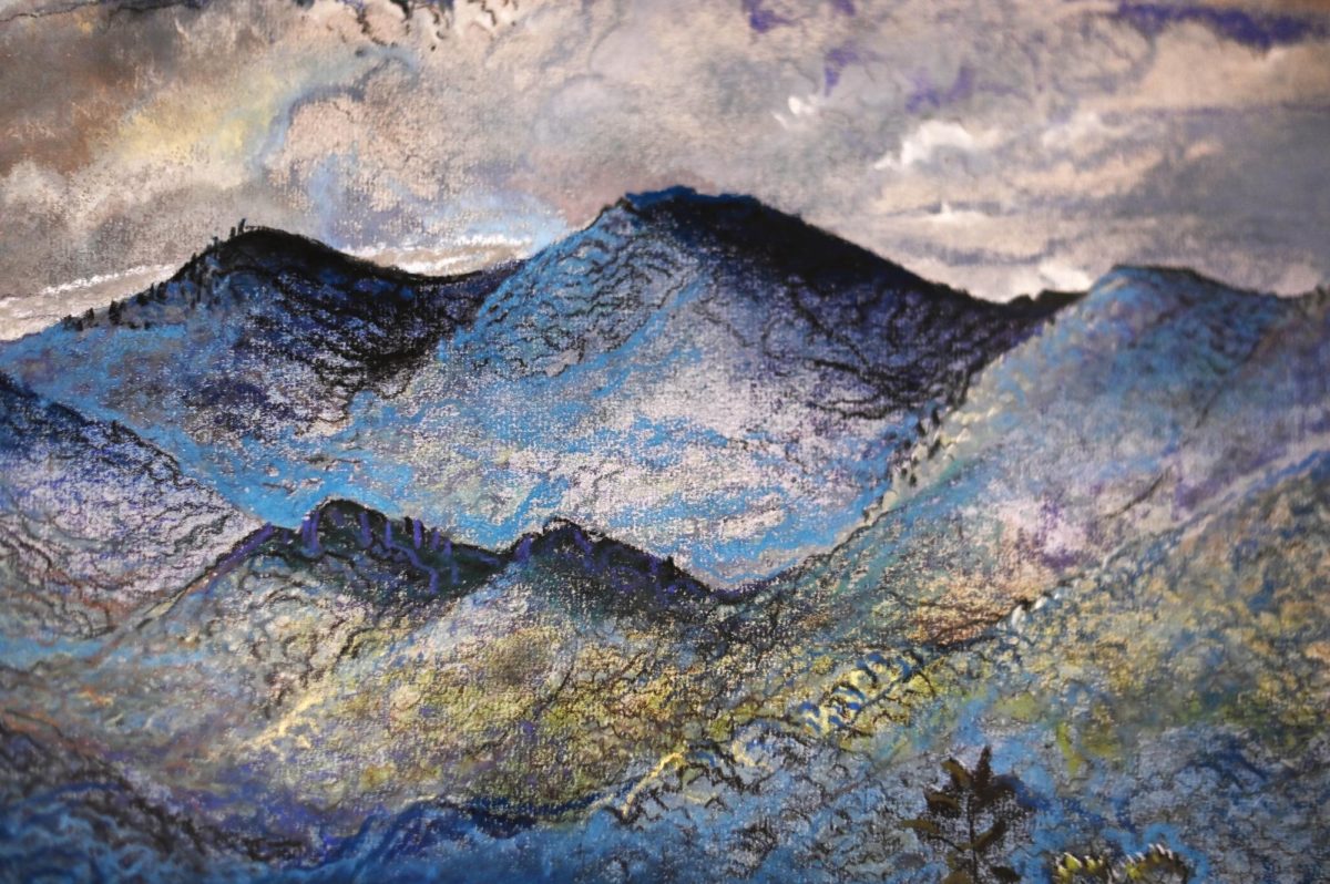 Close-up of an untitled landscape with blue mountains by Will Henry Stevens in the Your Brain on Art exhibit at the Gregg Museum of Art and Design on Friday, Sept. 12, 2025. The exhibit reimagines the Gregg's collection through the lens of neuroscience and explores how art affects us.