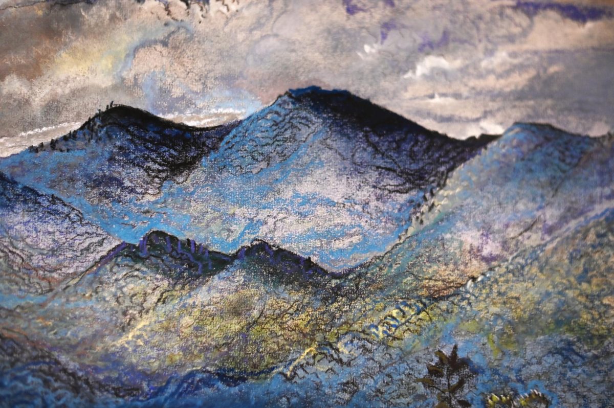 Close-up of an untitled landscape with blue mountains by Will Henry Stevens in the Your Brain on Art exhibit at the Gregg Museum of Art and Design on Friday, Sept. 12, 2025. The exhibit reimagines the Gregg's collection through the lens of neuroscience and explores how art affects us.