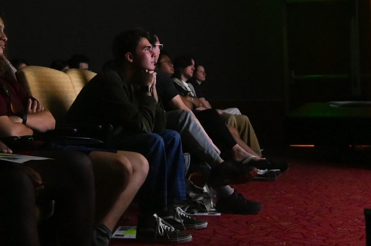 Grayson Snyder, a first-year studying materials science and engineering, watches intently during the "Growing Pains" Film Screening at D.H. Hill Library on Thursday, Aug. 27, 2025. Students gathered in the auditorium to watch "Growing Pains," a coming-of-age story about identity, sexuality and the aftermath of surviving cancer.