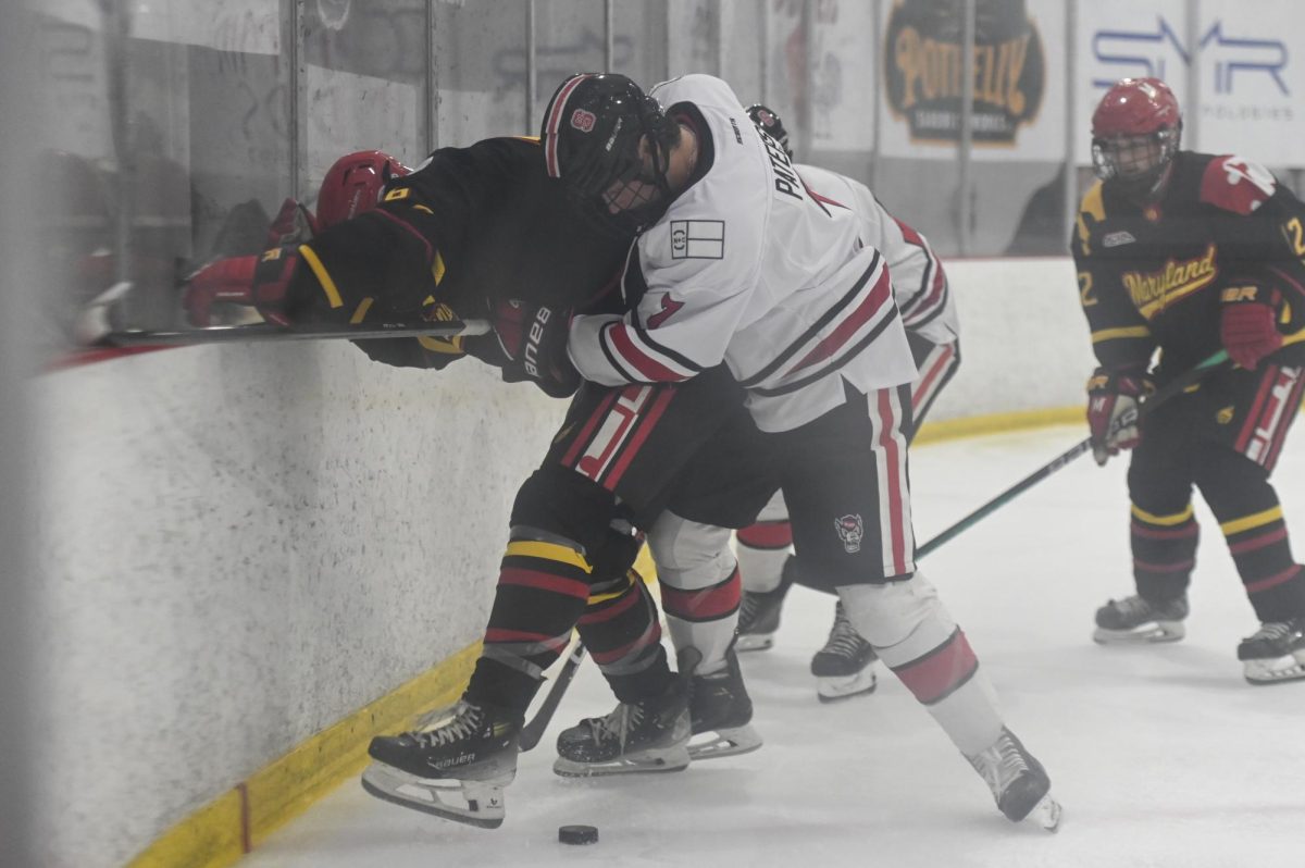 Freshman forward Ben Paterson fights for the puck during the game against Maryland at Invisalign Arena on Friday, Sept 26, 2025. NC State beat Maryland 4-1. 