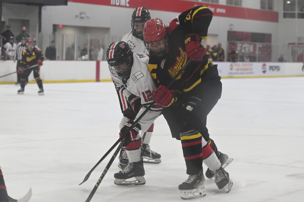 Freshman defenseman Mason Payne battles for control during the game against Maryland at Invisalign Arena on Friday, Sept 26, 2025. NC State beat Maryland 4-1. 