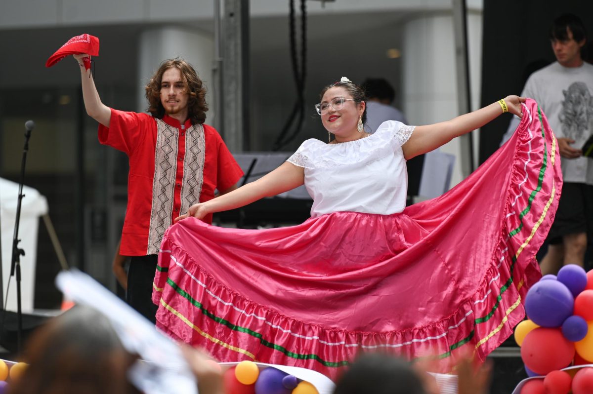 Samuel Antolick, a second-year studying mathematics, logic and methodology, and Samantha Villanueva Garcia, a second-year studying elementary education, perform on stage as Folklorico Club at NC State during La Fiesta del Pueblo at Fayetteville Street Historic District on Sunday, Sept. 21, 2025. NC State’s Folklorico Club promotes and celebrates folklorico dance traditions from across Latin America.