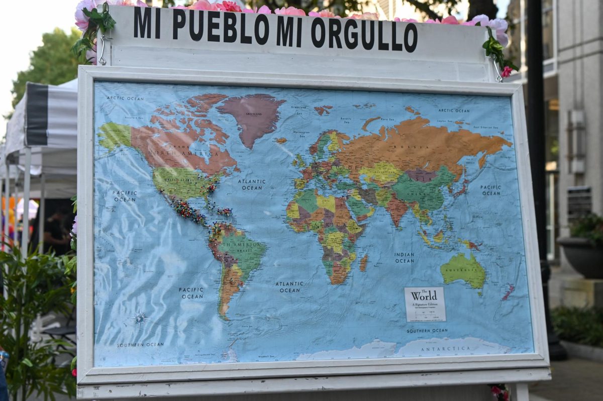 A map shows festivalgoers’ home countries and cities during La Fiesta del Pueblo at Fayetteville Street Historic District on Sunday, Sept. 21, 2025. The event, which draws thousands annually, is organized by El Pueblo to celebrate the pride and resilience of the Latine community.