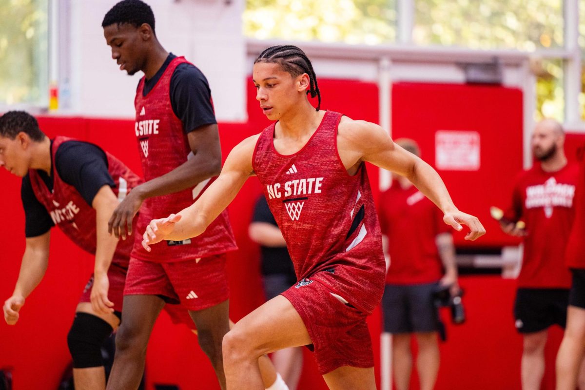 Freshman guard Matt Able stretches during the first official practice of the 2025-2026 season on Monday, Sept. 22, 2025, inside the Dail Basketball Center. The event gave reporters a chance to watch the Wolfpack up close as the team prepared for the upcoming season.