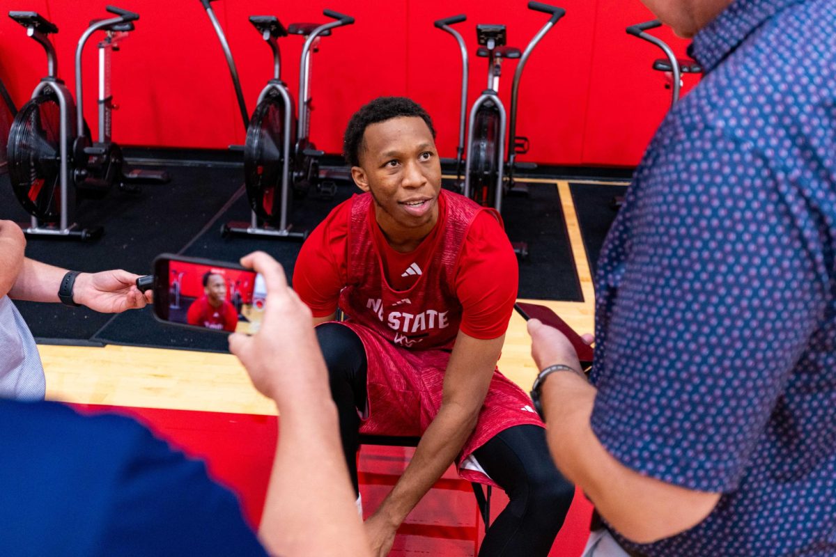 Senior guard Quadir Copeland ties his shoe while speaking to the media before the first official practice of the 2025-2026 season on Monday, Sept. 22, 2025, inside the Dail Basketball Center. The media session offered reporters a closer look at the Wolfpack as preparations for the new season began.