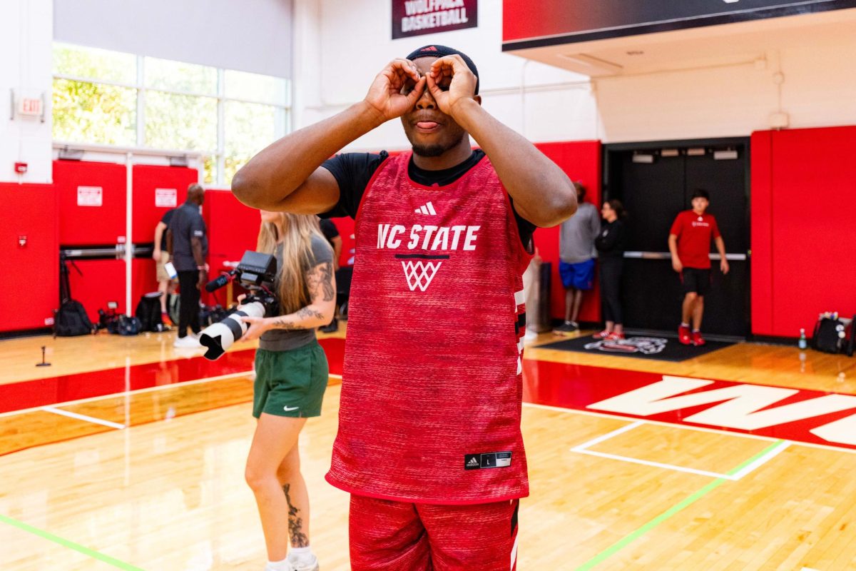 Senior guard Tre Holloman poses doing a three-point celebration before the first official practice of the 2025-2026 season on Monday, Sept. 22, 2025, inside the Dail Basketball Center. The annual media availability marked the start of another Wolfpack basketball season.