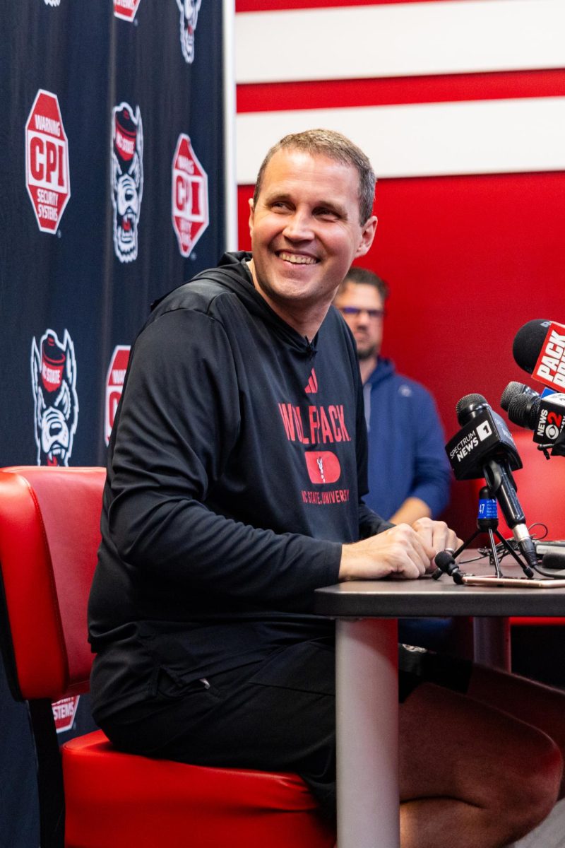 Will Wade, Head Coach of the NC State Men’s Basketball team, smiles after hearing a question from a reporter during his press conference inside the Dail Basketball Center on Monday, Sept. 22, 2025. The media session introduced Wade’s vision for the upcoming season and allowed reporters to ask questions about the team’s preparation.