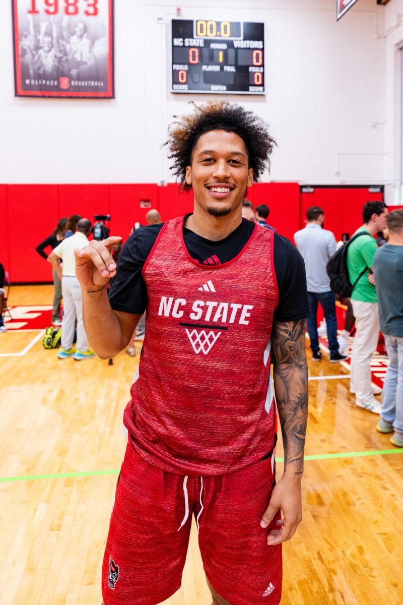 Senior forward Darrion Williams holds up a "wolfie" before the first official practice of the 2025-2026 season on Monday, Sept. 22, 2025, inside the Dail Basketball Center. The annual media availability marked the start of another Wolfpack basketball season.