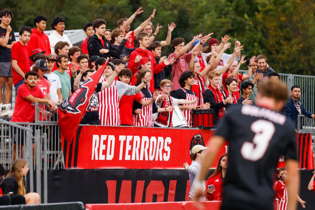 The Red Terrors student section put their hands in the air for a cheer during the game against William & Mary University at Dail Soccer Field on Tuesday, Sep. 16, 2025. NC State beat W&M 7-0.