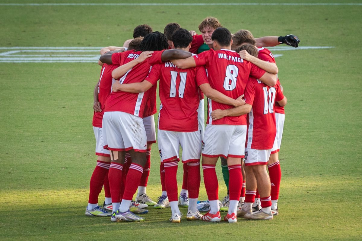 The men's soccer team huddles up before the game against FAU at Dail Soccer Stadium on Saturday, Sept. 13, 2025. The Wolfpack defeated the Owls 2-0.