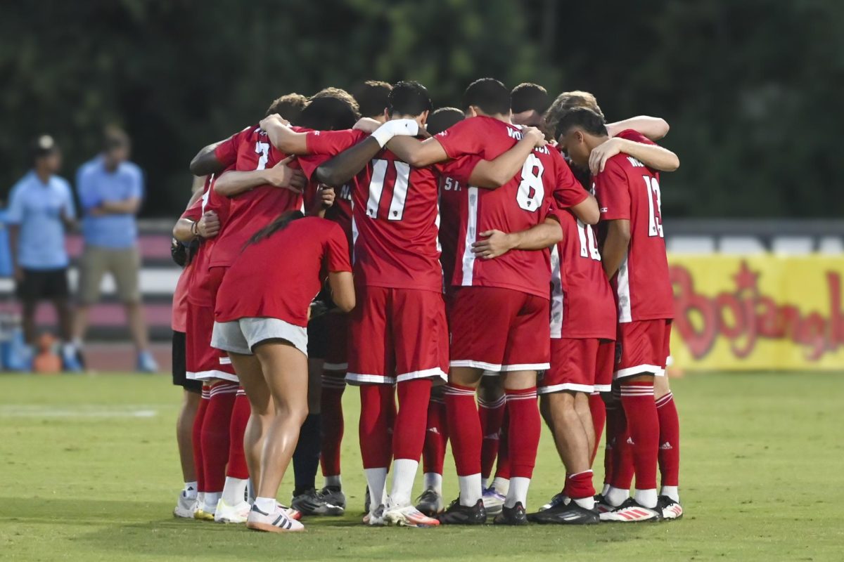N.C State's men soccer team huddles during the men's soccer match against UNC-Chapel Hill at Dail Soccer Field on Friday, Sept. 5, 2025. This game had a record breaking attendance of 5000.  NC State tied with UNC 0-0.