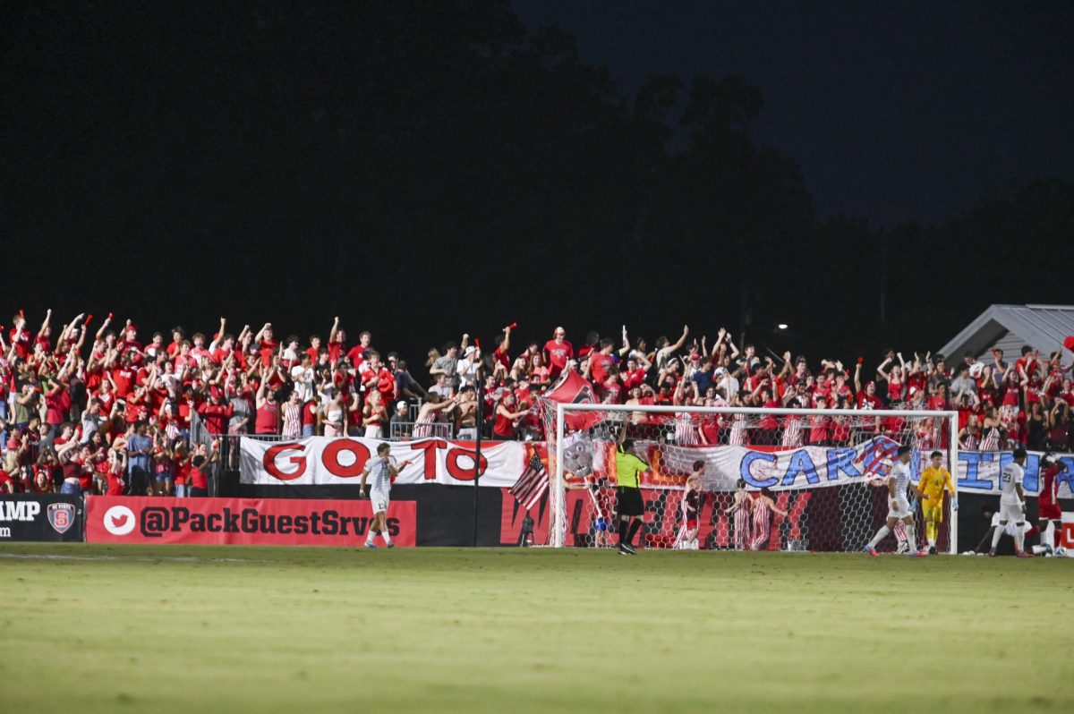 NC State fans cheer during the soccer match against UNC-Chapel Hill at Dail Soccer Field on Friday, Sept. 5, 2025. This game broke the attendance record with over 4,000 attendees being in the stadium. NC State tied with UNC 0-0.