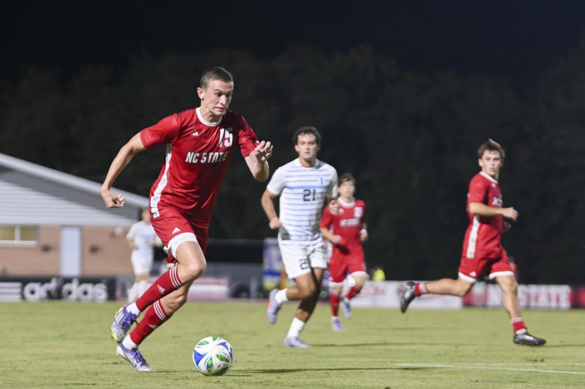 Redshirt junior Aidan Payne runs with the ball during the soccer match against UNC-Chapel Hill at Dail Soccer Field on Friday, Sept. 5, 2025. This game broke the attendance record with over 4,000 attendees being in the stadium. NC State tied with UNC 0-0.