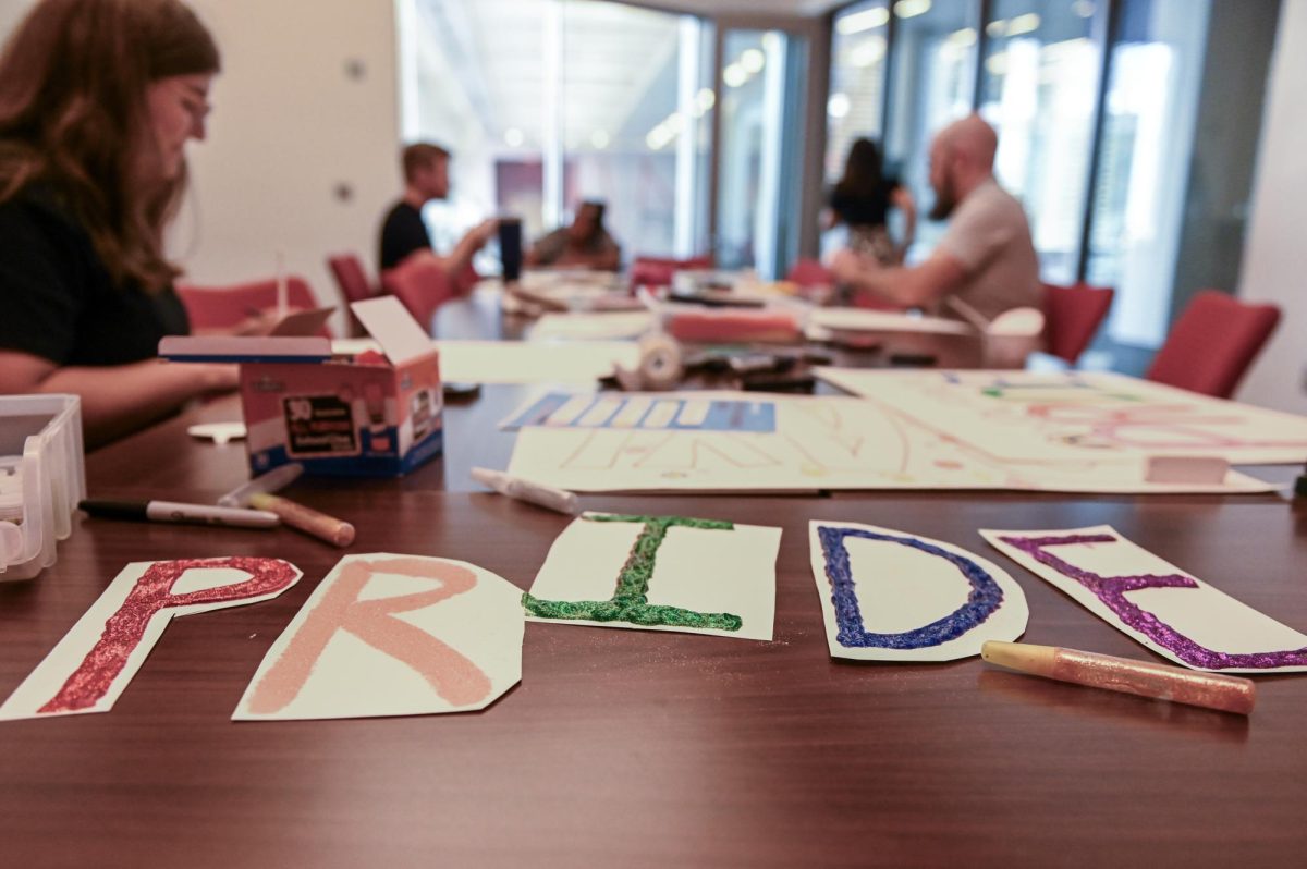 Lila Menard, a first-year in exploratory studies makes her own sign at the PrideFest poster-making event at Talley Student Union on Wednesday, Sept. 24, 2025. The poster-making event is one of the events the Pride Center holds to prepare for PrideFest on Oct. 7.