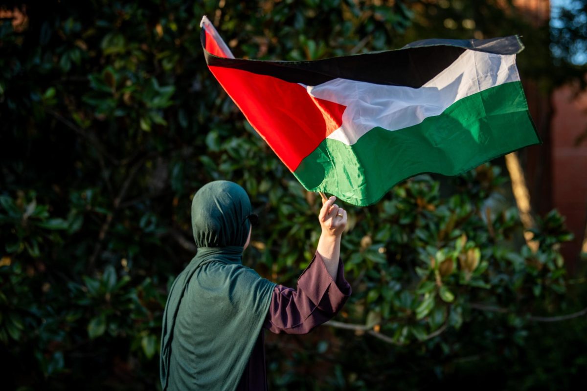A member of NCSU Students for Justice in Palestine, who declined to give their name, waves the Palestinian flag during the "There is no Back to School in Gaza" protest in the Court of North Carolina on Monday, Sept. 8, 2025. The Group honored students in Gaza and the West Bank with a series of chants and speeches.