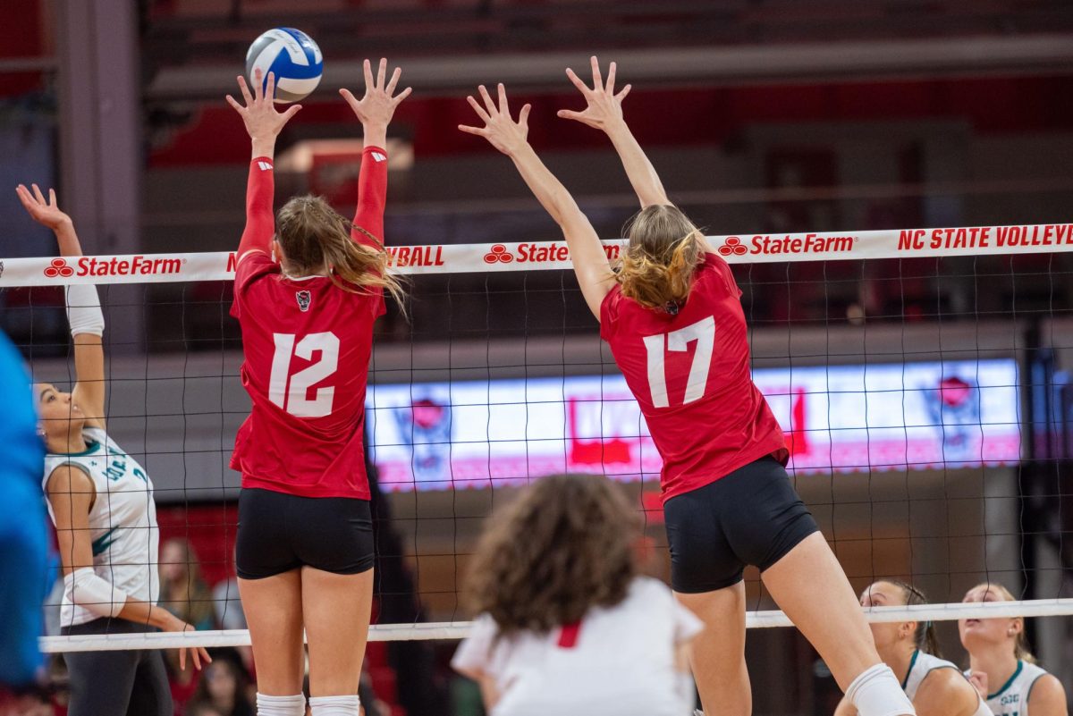Senior outside hitter, Courtney Bryant and freshman middle blocker, Lily Cropper hitting the ball during the match against Coastal Carolina in Reynolds Coliseum on Sunday, Sept. 14, 2025. NC State was defeated by Coastal Carolina 3-1.