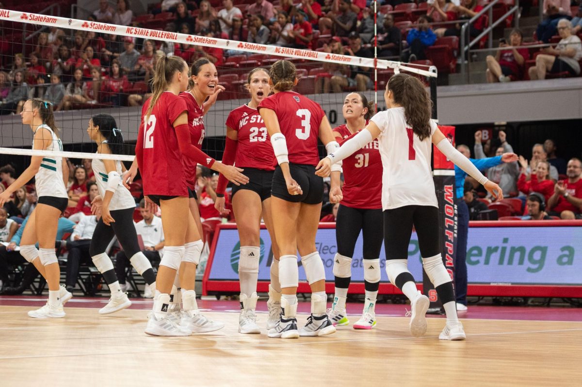 The volleyball team celebrates together during the match against Coastal Carolina in Reynolds Coliseum on Sunday, Sept. 14, 2025. NC State was defeated by Coastal Carolina 3-1.