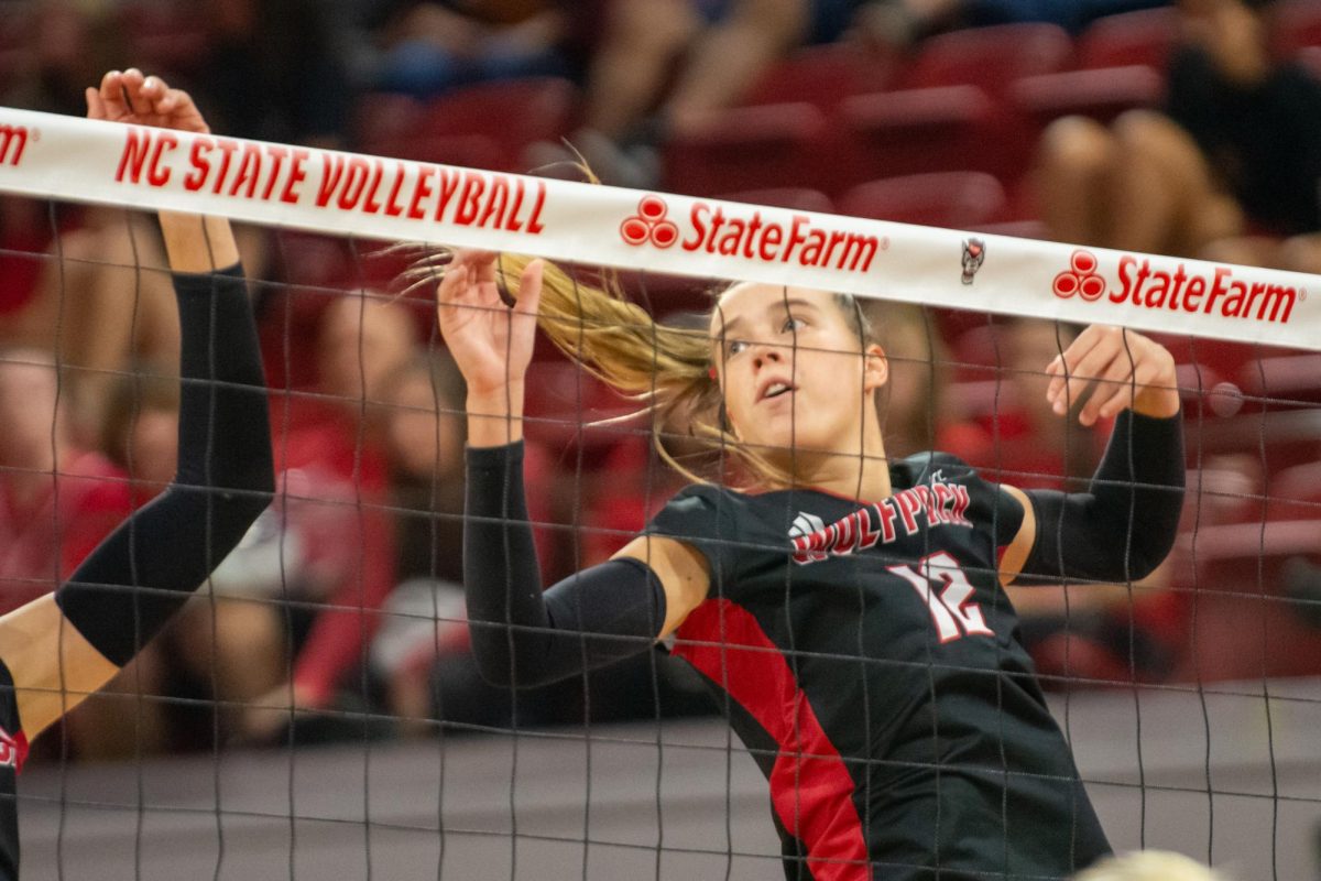 Senior outside hitter Courtney Bryant falls from her block during the match against Cleveland State in Reynolds Coliseum on Saturday, Sept. 13, 2025. Bryant made 12 digs. The Wolfpack defeated the Vikings 3-0.