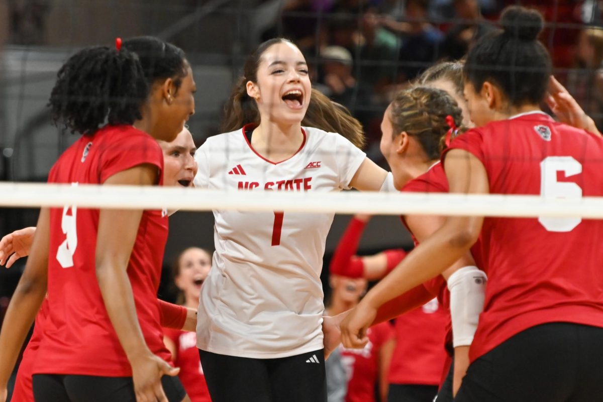 Freshman libero Zuzia Maciejewicz celebrates with her team during the match against South Carolina in Reynolds Coliseum on Friday, Sept. 10, 2025. Maciejewicz had five assists . NC State beat South Carolina 3-1.