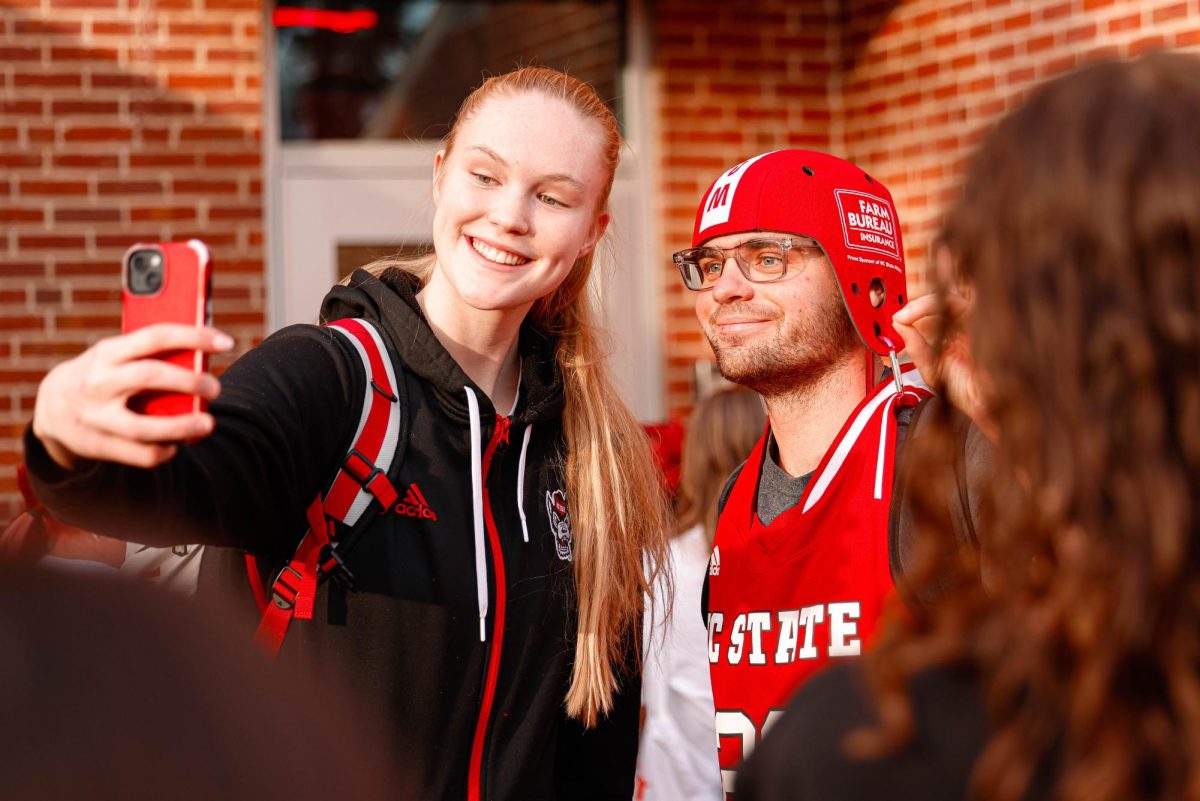 Freshman forward Tilda Trygger takes a selfie with Baxter Hayworth, a student studying English and history, during their welcome back to Reynolds Coliseum on Saturday, March 29, 2025. Trygger played in 34 games during her freshman season.