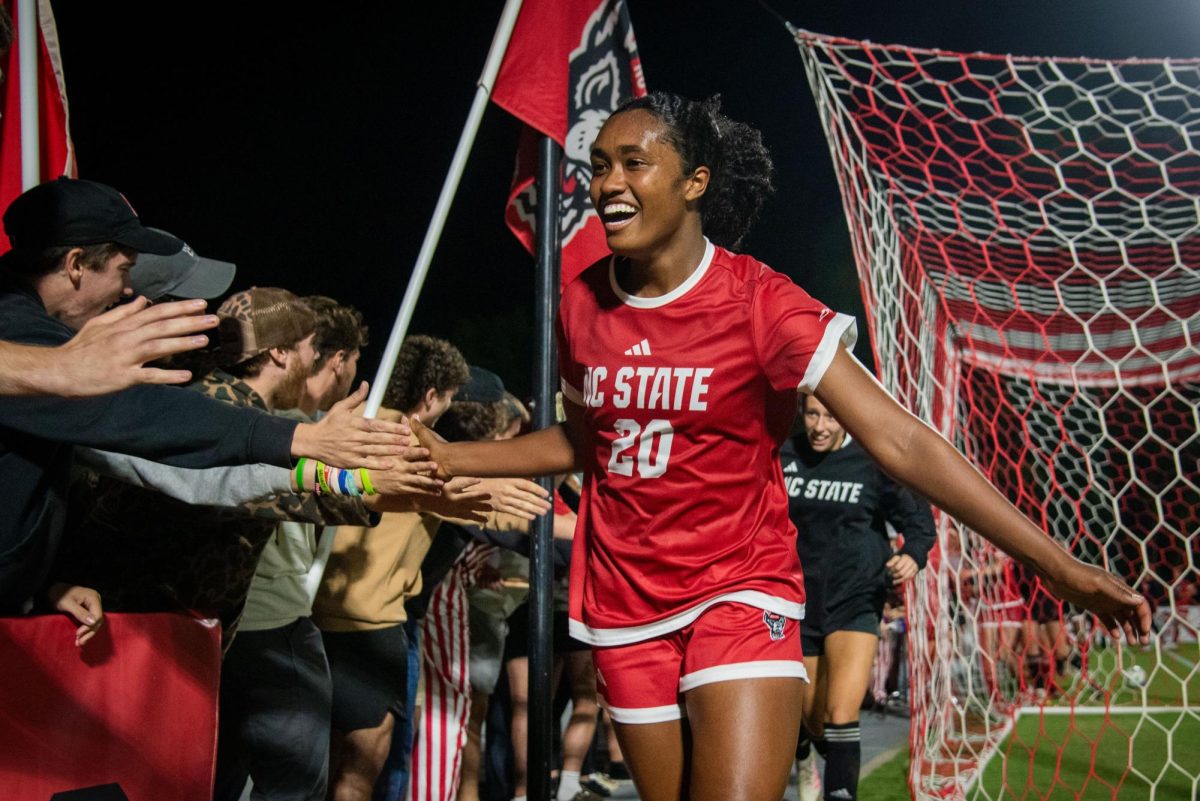Senior defender Brooklyn Holt high-fives members of the red terrors after the game against Campbell in Dail Soccer Stadium on Sunday, Sep. 7, 2025. The Wolfpack defeated the Camels 4-0.
