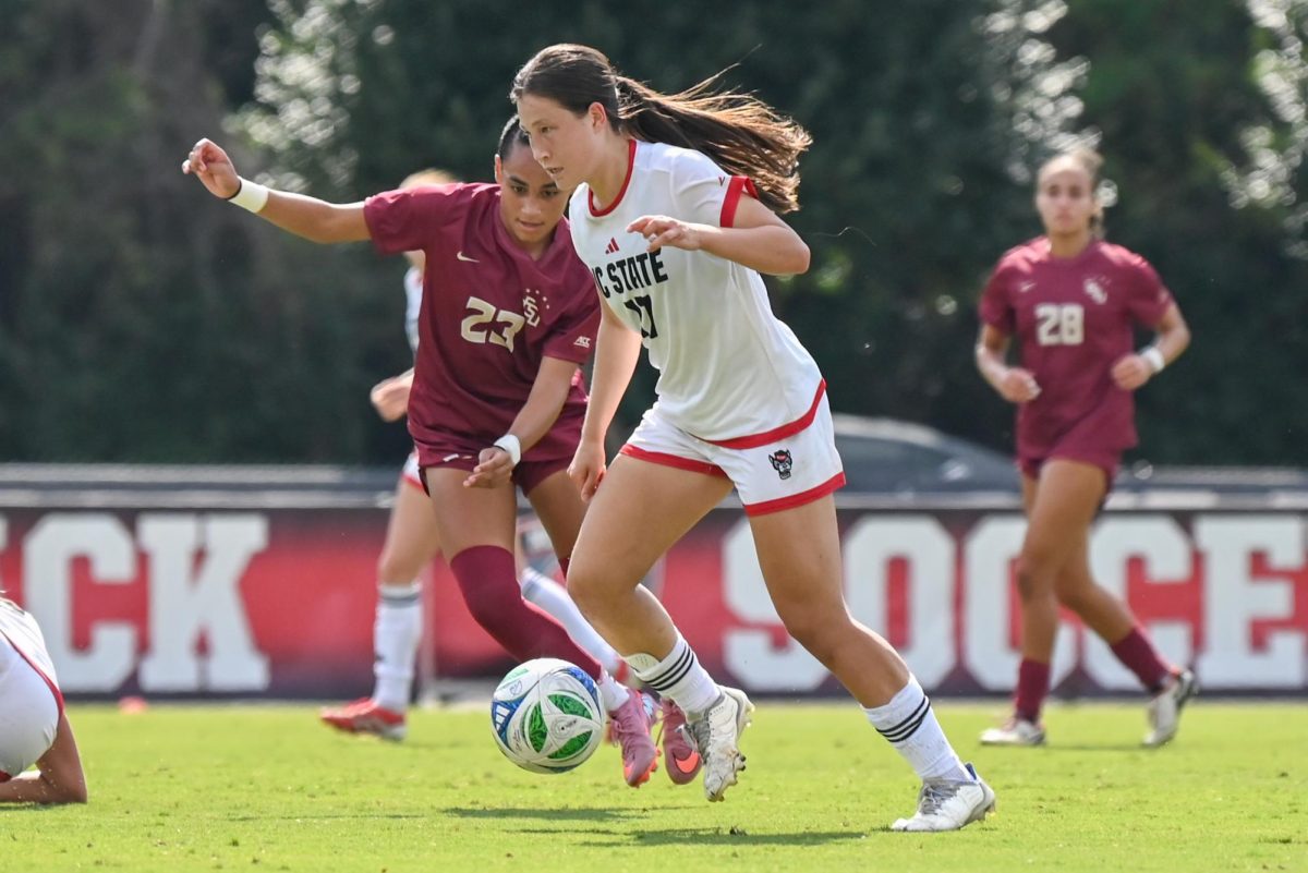 Freshman midfielder Emily Wong passes the ball during the game against Florida State in Dail Soccer Stadium on Sunday Sept. 21, 2025. NC State tied Florida State 1-1.
