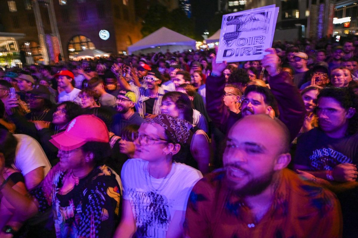 The crowd for Earl Sweatshirt enjoys the performance during day one of Hopscotch music festival at City Plaza in downtown Raleigh on Friday, Sept. 5, 2025. An audience member holds up Voir Dire, Earl Sweatshirt's 2023 album.
