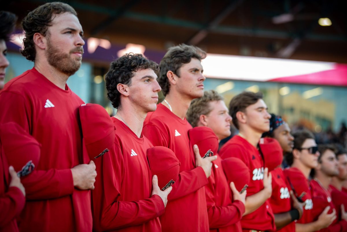 The NC State Baseball team stands for the national anthem before the exhibition against UNC at Durham Bulls Athletic Park on Thursday, Oct. 16, 2025. The Tar Heels defeated the Wolfpack 3-1.