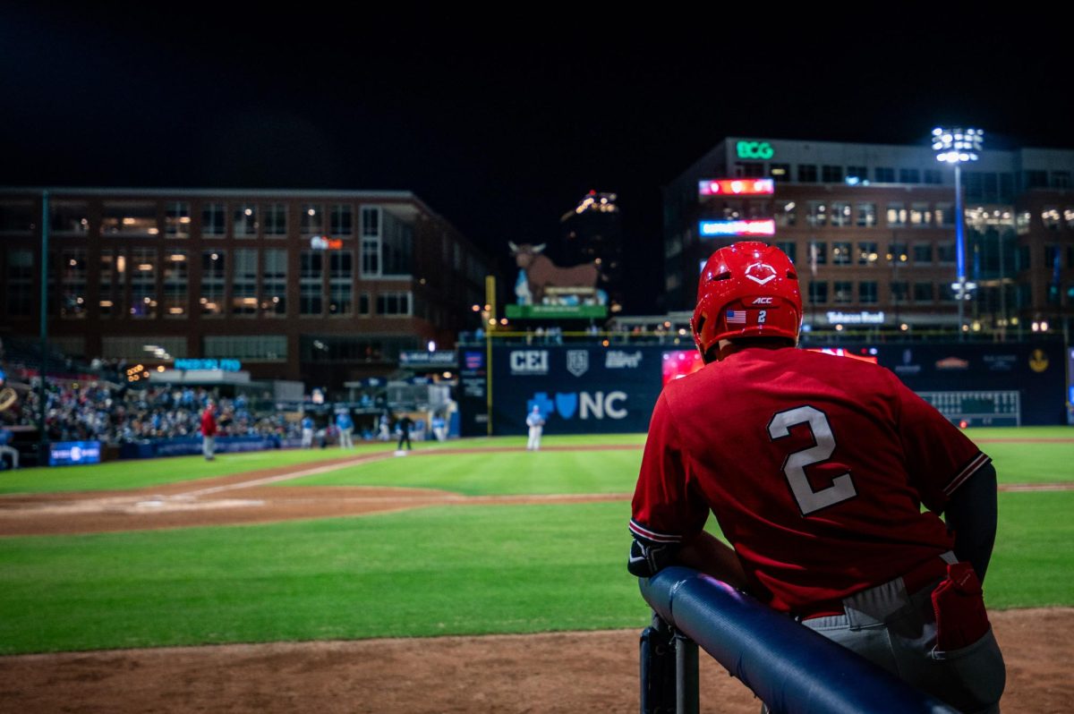 Sophomore infielder Mikey Ryan leans on the dugout railing during the exhibition against UNC at Durham Bulls Athletic Park on Thursday, Oct. 16, 2025. The Tar Heels defeated the Wolfpack 3-1.
