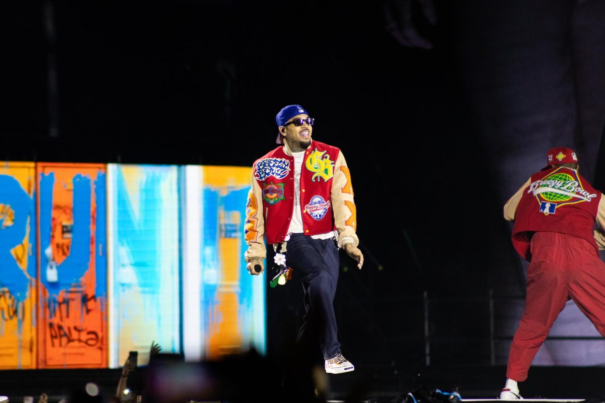 Chris Brown smiles on stage in Carter-Finley Stadium on Tuesday, Oct. 14, 2025. Chris Brown's last 12 consecutive studio albums have all debuted in the Top 10 of the Billboard 200 chart.
