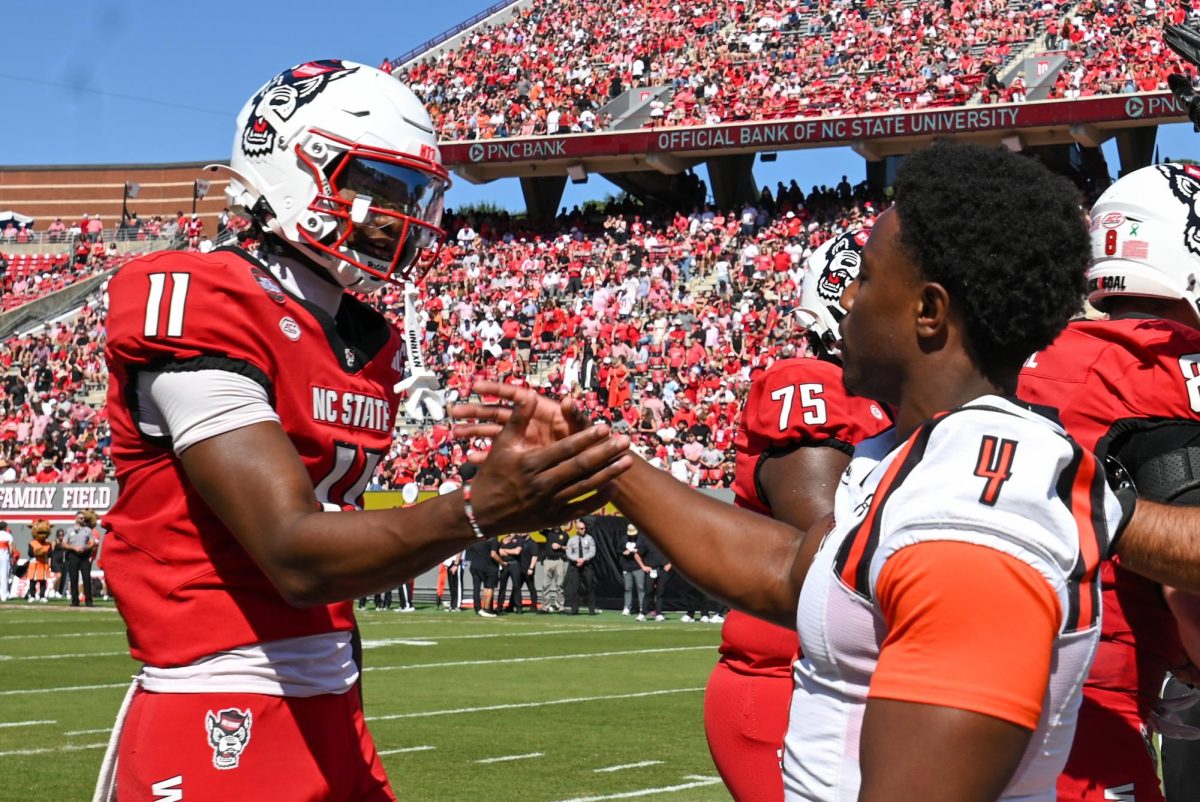 Sophomore quarterback CJ Bailey shakes hands with Campbell graduate student Mark Biggins before the game against Campbell at Carter-Finley Stadium on Saturday, Oct. 4, 2025. Bailey totaled 337 yards in passing. NC State beat Campbell 10-56.