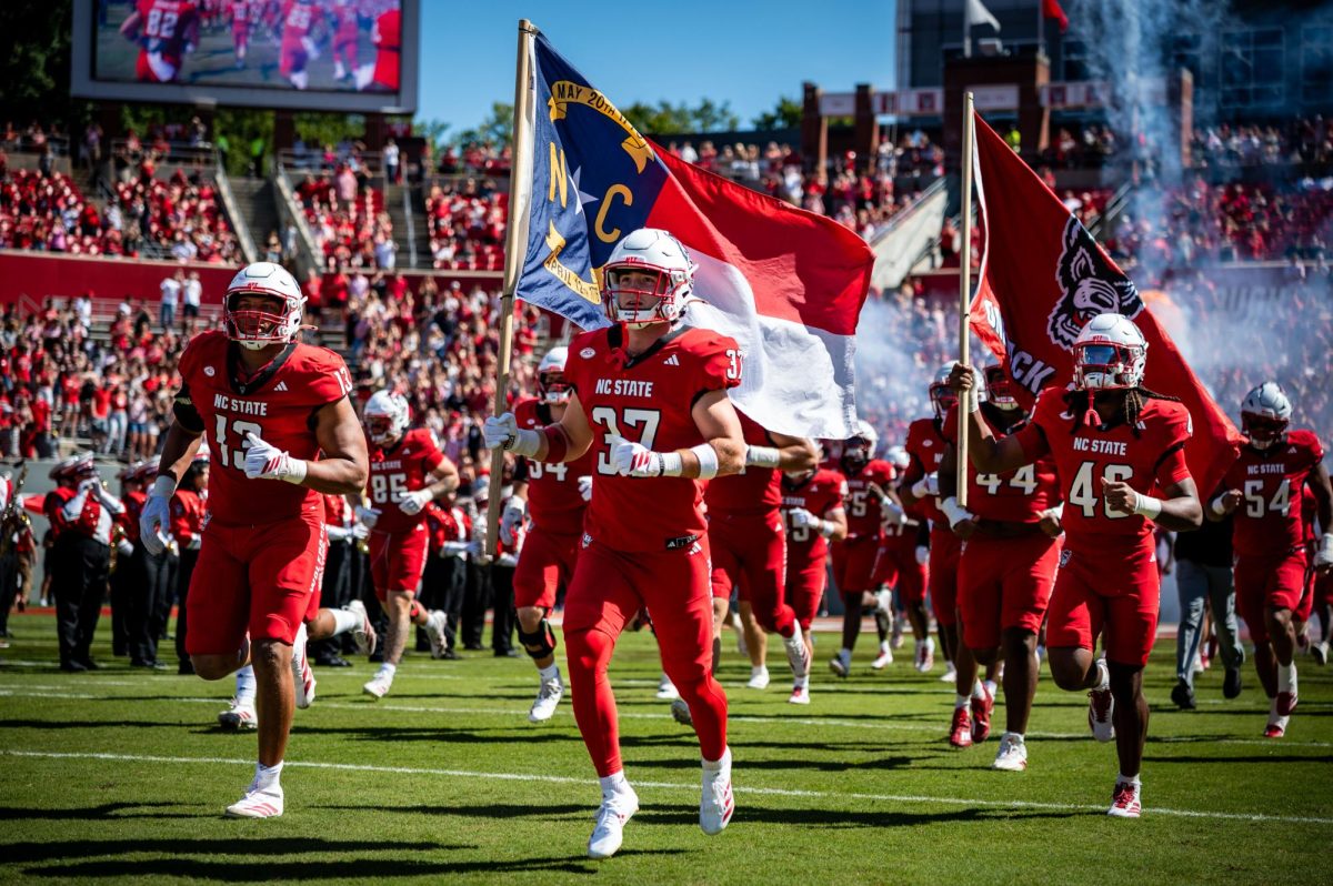 Redshirt freshman wide receiver Addison Carlson runs out onto the field before the game against Campbell in Carter-Finley Stadium on Saturday, Oct. 4, 2025. The Wolfpack beat the Camels 56-10.