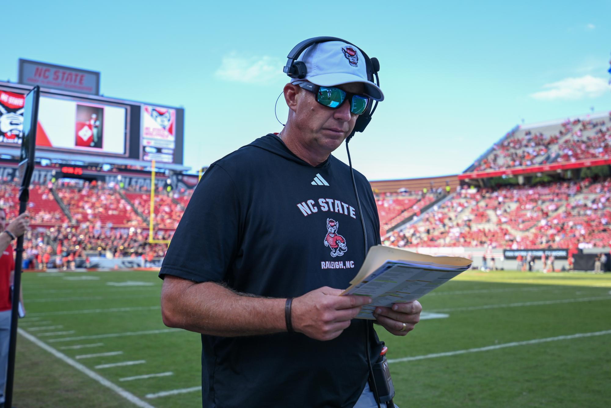 Head coach Dave Doeren reads over plays during the game against the Fighting Camels at Carter-Finley Stadium on Saturday, Oct. 4, 2025. The Wolfpack totaled 371 passing yards. The Wolfpack defeated the Fighting Camels 10-56.