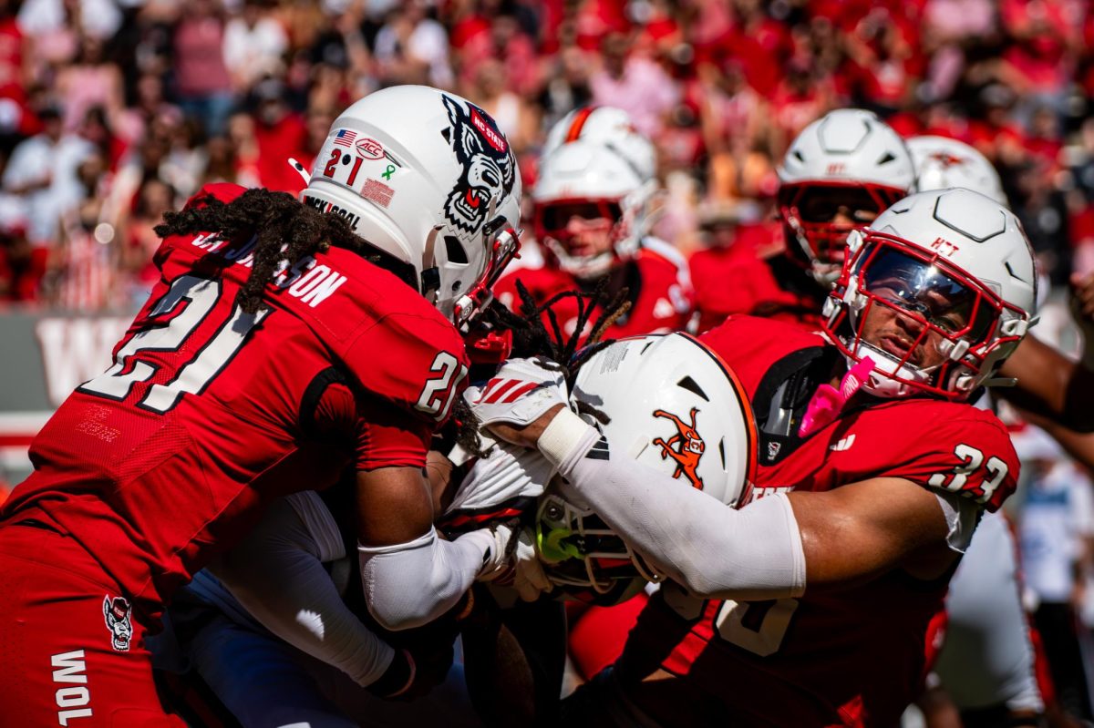 Senior cornerback Jamel Johnson and graduate linebacker Kenny Soares Jr. combine for a tackle during the game against Campbell in Carter-Finley Stadium on Saturday, Oct. 4, 2025. The Wolfpack beat the Camels 56-10.