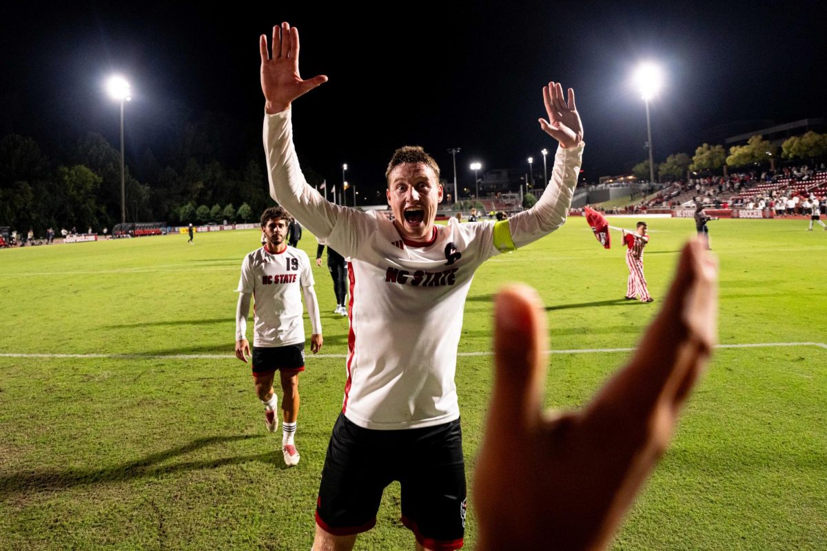 Sophomore defender Nikola Markovic yells before high-fiving a fan after the game against Clemson in Dail Soccer Stadium on Friday, Oct. 10, 2025. Markovic played 90 minutes. NC State defeated Clemson 1-0.