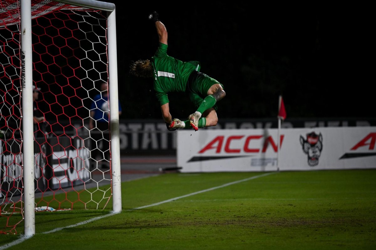Senior goalkeeper Logan Erb jumps to block the ball during the game versus Virginia at Dail Soccer Stadium on Sunday, Oct. 5, 2025. Virginia beat NC State 1-0.
