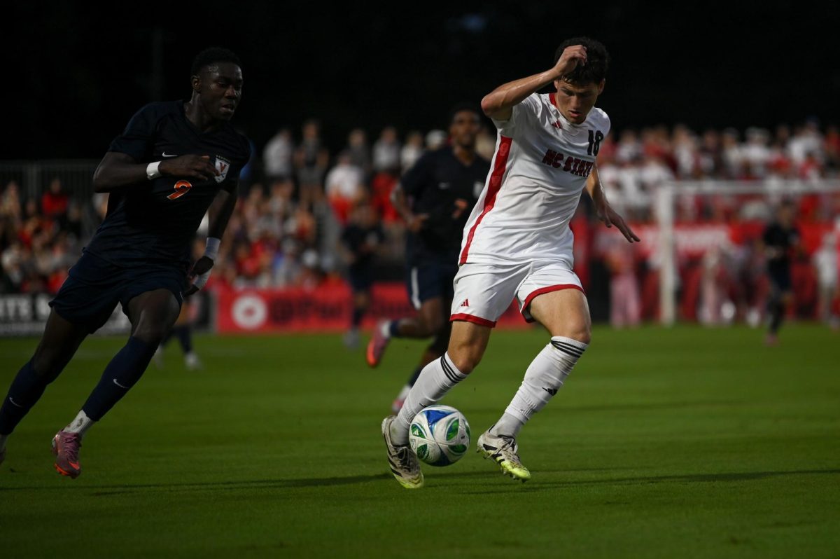 Junior defender Isaac Heffess runs with the ball during the game versus Virginia at Dail Soccer Stadium on Sunday, Oct. 5, 2025. Virginia beat NC State 1-0.