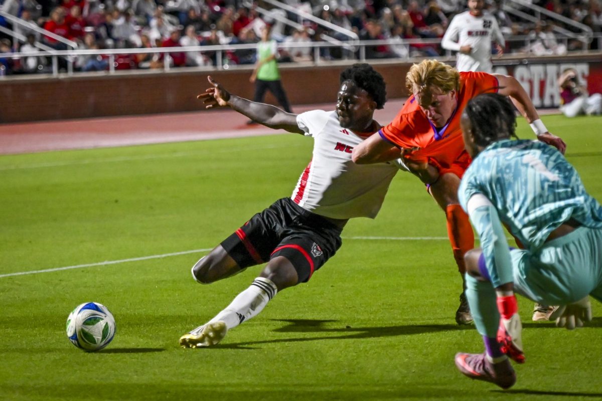 Sixth year forward Ibrahim Conde reaches for the ball during the game against Clemson at Dail Soccer Stadium on Friday, Oct. 10, 2025. The Wolfpack defeated the Tigers 1-0.